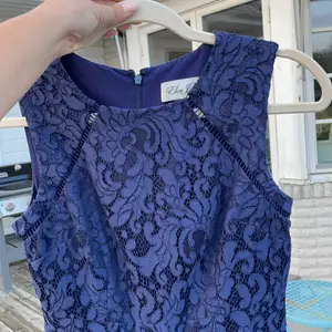 Great condition, only used one time, nice quality with lace and lining. Cute details, beautiful for special occasions. Ends right above the knees.