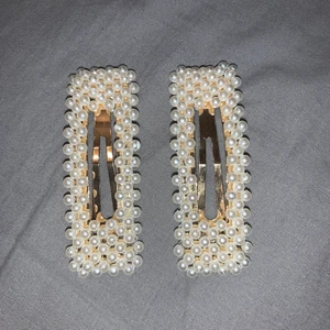 Hårspännen från glitter - Hårspännen från glitter i guld med pärlor på. Knappt använda.