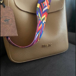 Bh polo club väska  - Helt oanvänd Beverly hills polo club väska. Nypris 1199. Axelbandet går att ta av och byta. Hämtas centralt Örebro eller skickas mot fraktkostnad. 