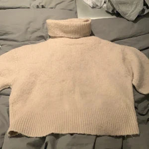 Beige  stickad tröja  - Mycket skön stickad tröja. Den är croppad så den är kort i modellen.