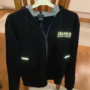 Hugo boss hoodie, storlek M - Plagget är i bra skick utan några skador eller fläckar. Nypris var 1099kr 