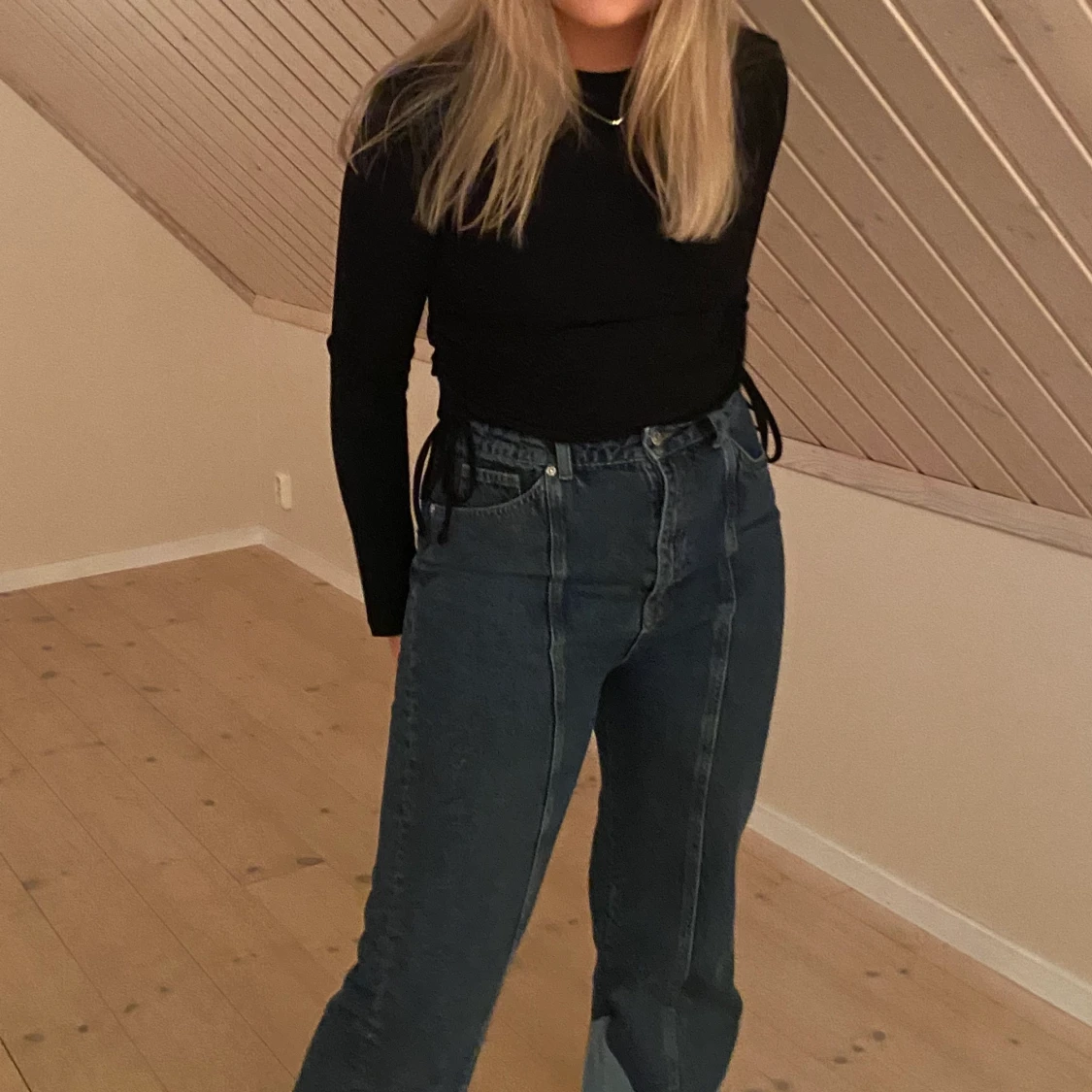 Svart tröja med knytdetalj på sidan