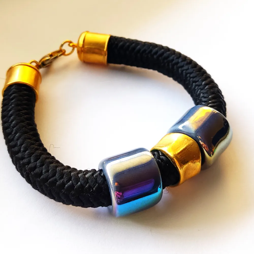 Black handmade bracelet with blue celamic beads and gold elements, new, 22cm length . Accessoarer.