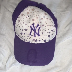 Lila Keps - Lila keps med stjärnor på från okänt märke. Pappa köpte den till mig. Nästan aldrig använd. Köparen står för frakt