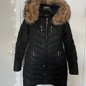 Hollies davos - Hollies jacka i modellen Davos, strl 34. Jackan fyller sin funktion men är väl använd och sliten. Används mer som en slit och släng jacka, därav priset. Jackan säljs tillsammans med äkta päls.