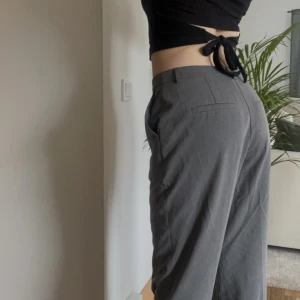 Gråa kostym - Gråa kostymbyxor från Na-kd. Älskar verkligen dessa byxor men de har blivit lite stora för mig. Jag har sytt ihop slits i benslut men det är bara att sprätta upp om man vill ha slits. Säljer billigt då de är använda men utan några defekter.