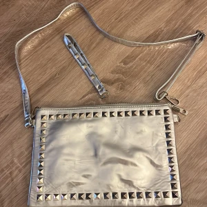 Silver vintage väska. - Kan kopplas med de två respektive kedjorna, men den korta går tyvärr inte att koppla. Så du kan använda den långa kedjan eller bara hålla den i handen!