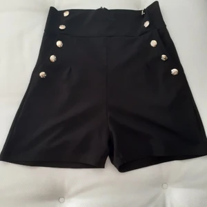 Black shorts - Black shorts with gold buttons and a side zip  - Size M  -Made and bought in Italy  💫Dont be hesitant to message for any questions about the product (Only in English) 💫