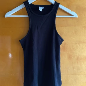 Tanktop från Other Stories - Fint svar minne från Other Stories. Säljes då jag inte tycker att det sitter bra på mig. Använt några gånger bara, så o fint skick. Perfekt till vår och sommar 🖤 Passformen är som bild nummer två, men mitt linne jag säljer är svart!