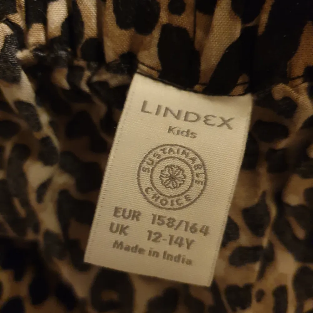 En lång leopardmönstrad kjol från Lindex. På sidan så är det volanger och en rosett, som man kan knyta om och själv välja hur man vill ha den. Kjolen har även resor runt midjan. Kjolar.