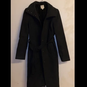 Mörkgrå kappa  - En helt ny snygg kappa, knappt använd då den tyvärr är för liten för mig. Köpte den för 900kr. 
