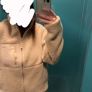 Teddy jacka - En ”jacka” från bikbok dom är väldigt varm och skön, fodrad inuti därför kan den användas som en jacka nu i höst/vinter/vår. Fickor på sidorna utan dragkedja men en ficka med dragkedja på bröstet. Använd endast 3 gånger, den är i nytt skick.