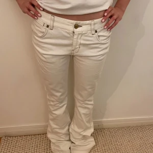 Vita low waist bootcut jeans - Snygga vita bootcut jeans med låg midja. Hon på bilder är 165. Innerbenslängden: 82cm.  Midjemått: 37cm tvärs över