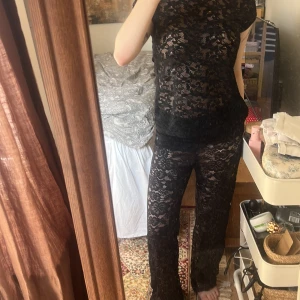 Svart spetsblus/festtopp😍 - Säljer en elegant svart spetsblus med korta ärmar. Perfekt för en stilren look med ett vackert mönster som ger en sofistikerad touch. Passar bra till både byxor och kjol. 