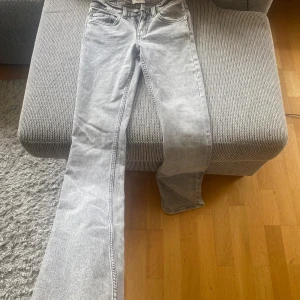 Grå bootcut jeans med vintage vibe low boot  - Säljer ett par ljus gråa jeans i storlek xxs byxorna är full lenght använt dem en gång bara eftersom att dem var för små på mig