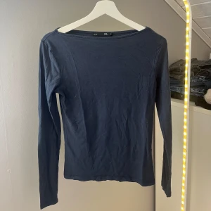 Mörkblå långärmad tröja lager 157 - En basic mörkblå långärmad tröja från lager 157 med rund halsringning. Tröjan är i mjuk bomull och har en enkel, clean look som funkar till allt. Perfekt att styla med jeans eller kjol. Knappt använd!
