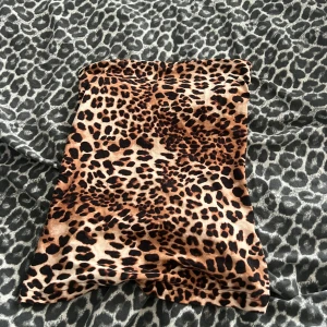 Leopardmönstrad tubtopp - Snygg tubtopp med leopardmönster i bruna och svarta toner. Toppen är axelbandslös och har en tight passform som sitter på plats. 
