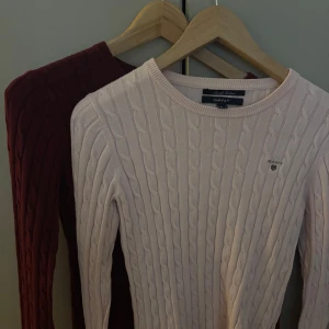 GANT kabelstickad tröja rosa & vinröd - Två kabelstickade tröjor från GANT i storlek S. En i ljusrosa och en i vinröd. Superträndiga och i väldigt bra skick. 90 kronor tillsamans och 50kr styck!