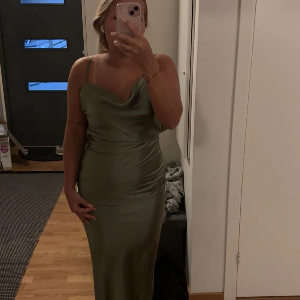 Snygg grön balklänning från Boohoo i ett glansigt material. Klänningen är helt ny och har köpts för 800kr. Jag säljer den för att jag beställde i fel storlek, så den är helt oanvänd.. Mekot.
