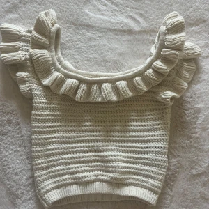 Beige stickad topp med volang - Supersöt beige stickad topp med breda volangdetaljer runt halsringningen och axlarna. Toppen äri storlek XS från HM. 💞