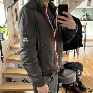 Moncler windbreaker - Super snygg Moncler windbreaker i jätte bra skick. Använd fåtal gånger. Självklart 100% äkta som man även ser när man skriver in koden på hemsidan, se bild 5🤝storlek 3, motsvarar en S eventuellt M. Pris kan diskuteras vid snabb affär🤝
