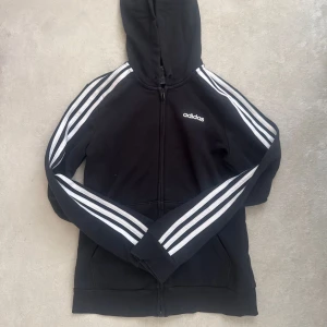 Svart huvtröja från Adidas - Klassisk Adidaströja. Tröjan är i storlek S. Säljer eftersom jag har många huvtröjor. Är i väldigt fint skick.