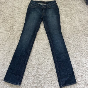 Mörkblå jeansbyxor från Zara Woman vintage  - Snygga mörkblå vintage jeansbyxor från Zara Woman med klassisk femficksdesign. Jeansen har kontrastsömmar och en stilren läderpatch bak i midjan. Storlek 40 (men sitter som en 36) 