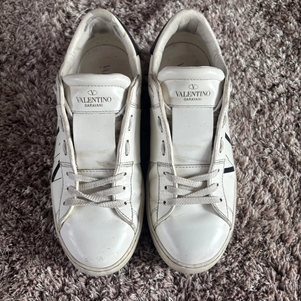 Valentino ”open” i vit färg med ”VLTN” text. Väldigt efterfrågad modell, Dam storlek 37 1/2. Fint skick överlag, lite slit på en hälen se bild. Skriv för mer bilder/info. Nypris ca 7000 :-❤️. Kengät.