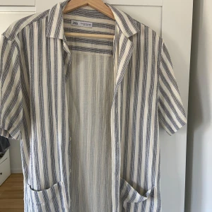 Zara pike M - Fin randig piké/skjorta från Zara. Vit med mörkblåa/svarta ränder. Fint skick  M