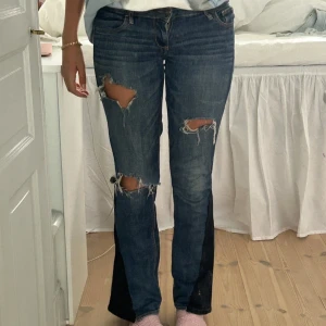 Abercrombie and fitch lågmidjade jeans  - Jättelågmidjade jeans! Jag har sytt in ett inlägg så att de är flare! Jag har även gjort slitningarna själv! Alltså är dessa jeansen helt unika, finns inga som dessa 💕