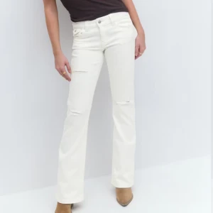 Vita bootcut jeans med slitningar - Snygga vita jeans med bootcut-passform och diskreta slitningar vid knäna. Dom är uppsprätta längst ner❤️Passar mig som har storlek S!!