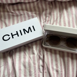 Bruna solglasögon från CHIMI - Solglasögon från CHIMI i modell 02 färg ecru.  Har använts kanske tre gånger, med hela orginal förpackningen kvar. De har ett minimalt jack i bågen som synns på sista bilden. Köpt i butik för några år sedan, pris kan diskuteras 