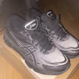 Svarta Asics Gel-Quantum 360 sneakers - Säljer ett par Asics Gel-Quantum 360 sneakers i svart och grått med coola detaljer och mönster på sidan. Skorna har snörning, rund tå och en chunky platt sula som ger grym komfort. Perfekt för dig som gillar sportig stil och vill ha något som sticker ut.inga hål eller nånting heller nypris är 2400kr
