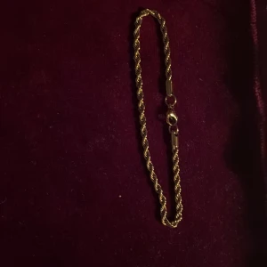 Guldigt tvinnat armband - Snyggt armband i guldfärgad metall med tvinnad kedja och klassisk karbinlås. Priset kan diskuteras vid snabb affär