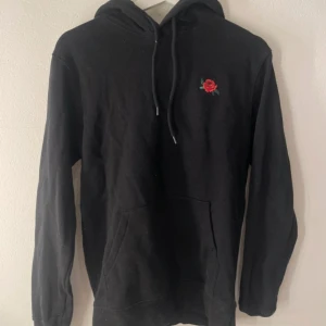 Svart hoodie med rosdetalj - Säljer en stilren svart hoodie från H&M. Ska flytta snart så vill gärna bli av med allt så fort som möjligt (pris kan diskuteras)💕