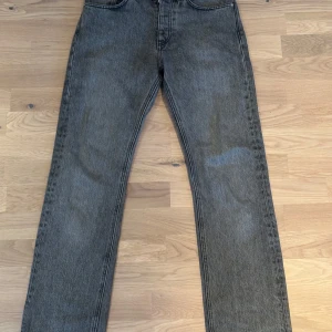 Grå jeans från HOPE - Säljer ett par grå jeans från HOPE med raka ben i modellen RUSH. Jeansen har normal passform och stängs med knapp. Storleken är W27, men passar som W29/30 på ”vanliga” jeans då HOPE sitter tajtare än vanligt. Jeansen är knappt använda och har inga defekter!