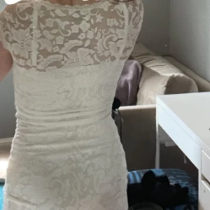 Vit spetsklänning från Gina  - Kort vit klänning i spets från Gina  med v-ringning och korta ärmar. Klänningen är i strl xs och passar tyvärr inte mig längre. Perfekt för student, skolavslutning eller konfirmation! 💕Klänningen är bara använd några gånger och i fint skick.