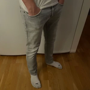 Ljusgrå jeans från Dondup - Snygga ljusgrå jeans från Dondup med en klassisk femficksdesign. De är tillverkade i ett mjukt denimtyg. Perfekta för en avslappnad stil. Knappt använda strl 34 men sitter som 33