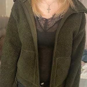 Olivgrön teddyjacka - Mysig olivgrön teddyjacka med dragkedja framtill. Perfekt för kyliga dagar med sin fluffiga och varma design. Jackan har långa ärmar och en enkel stil som passar till det mesta. Slutsåld från Hm❤️
