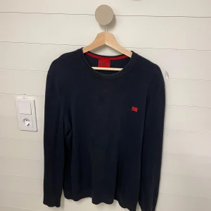 Hugo tröja - Säljer denna mörkblå Hugo tröjan i riktigt bra skick utan några defekter eller liknande. 