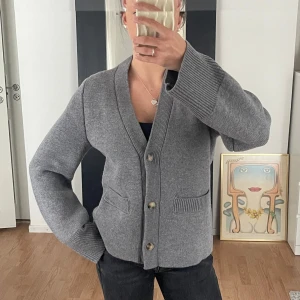 Grå ullkofta från H&M - Säljer en stilren grå kofta från H&M i mjuk ull. Strl:S, använd 1 gång. 