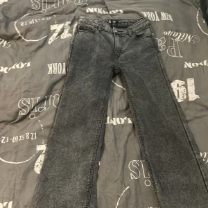 Grå wide jeans från Wera - Säljer ett par grå jeans från Wera i wide-modell. Byxorna har klassisk femficksdesign, raka vida ben och knappgylf. Perfekta för dig som gillar en avslappnad och trendig stil.