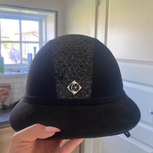 Svart glittrig ridhjälm från Charles Owen - Charles owen hjälm, bra skick inte ramlat av med och slått i huvudet.