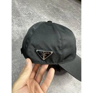 Prada keps - Säljer min min prada keps som är köpt från Vestiaire. Kepsen är helt oanvänd efter jag köpt den och säljer då den inte passade mig. Kepsen är äkta och autentiserad. Beställnings bevis finns.