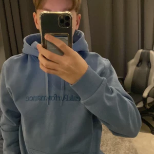Blå hoodie från Peak Performance Aldrig använd köpt för 1200kr  - Säljer en blå hoodie från Peak Performance i storlek S. Tröjan har huva med dragsko och en stor magficka framtill. Perfekt för en avslappnad stil och enkel att matcha med jeans eller mjukisbyxor.