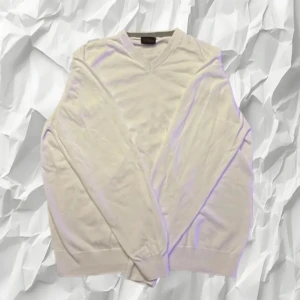 Vit tröja från Oscar Jacobson - Säljer en stilren vit tröja från Oscar Jacobson. Tröjan har en v-ringad design och är tillverkad i ett mjukt material. Perfekt för en klassisk och elegant look. Hör av er vid frågor eller prisförslag!😁