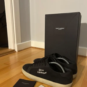 Svarta sneakers från Saint Laurent - Snygga svarta sneakers från Saint Laurent med vit logga på sidan. PRIS KAN DISKUTERAS‼️ Inte använda mycket, storlek 41. Säljer pga för små