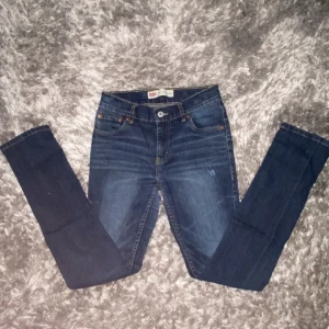 Levi's jeans - Säljer ett par klassiska Levi's 514 jeans i mörkblå denim. De har raka ben, fem fickor och snygga kontrastsömmar. Perfekta för dig som gillar en tidlös look med lite streetkänsla. Levi's-patch bak i midjan och diskret logga på fickan. Kom privat för mer info och pris!💯