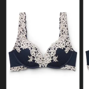 Mörkblå spetslinnetopp med blommönster - Supersnygg mörkblå linnetopp med krämvit spets och blommigt mönster. Toppen har breda axelband och vacker spetsdetalj längs kanterna som ger en romantisk vibe. Perfekt att styla under en öppen skjorta eller kavaj.