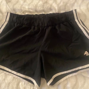 Svarta Adidas badshorts  - Knappt använda vet inte exakt storlek men skulle säga M